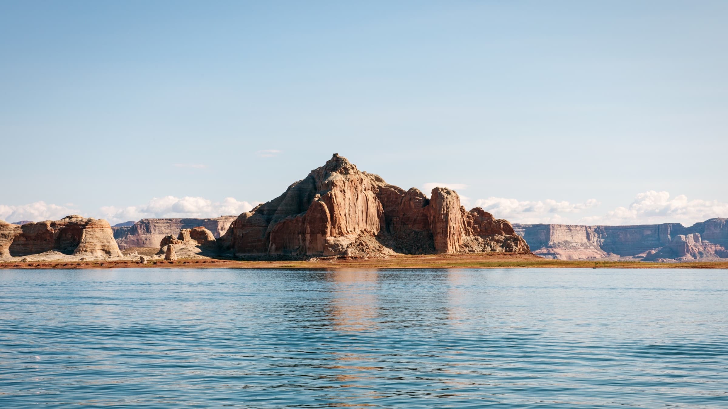 A monumental sandstone formation reflected in still water